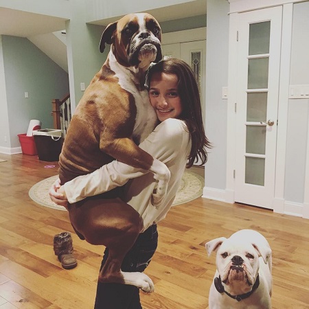 Hayley carrying her biggest dog named Piper